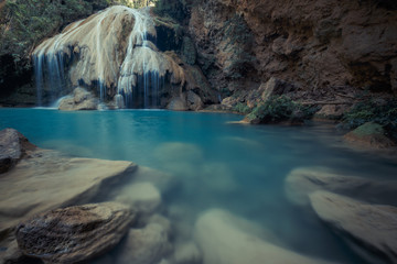 Naklejka premium wonderful waterfall with colorful tree in thailand