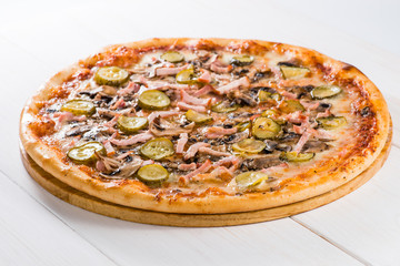 tasty pizza on a white wooden background