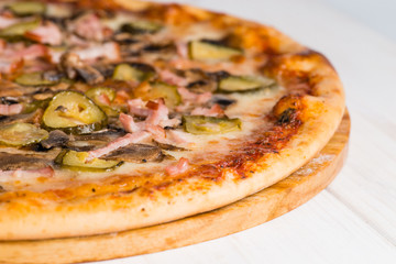 tasty pizza and text space on a white wooden background