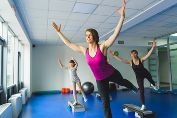 Obraz premium Two young woman and little girl doing gymnastic exercises 