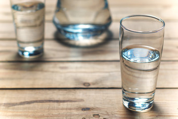 Glasses of water on wooden table. Selective focus.
