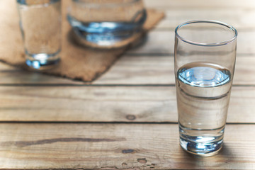 Glasses of water on wooden table. Selective focus.
