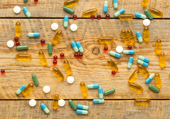 colorful medical pills isolated on wodden table