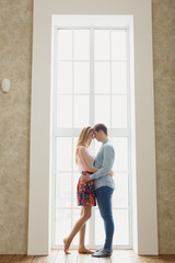 man and woman near a large window.