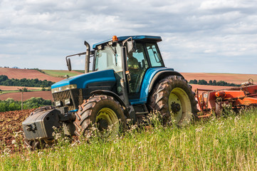 Farmer in tractor working on a field