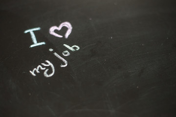 Fototapeta premium Text i love my job written with chalk in old board