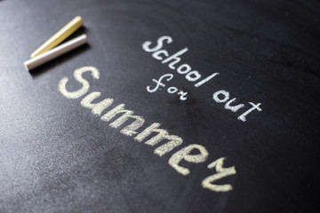 Fototapeta premium The words School's Out written on a chalkboard