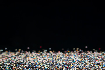 Shiny colorful multicolored background with black copy space. The texture.