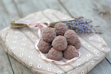 Chocolates on the pillow with a ribbon and flowers