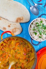 Vegetable korma curry with naan bread and rice
