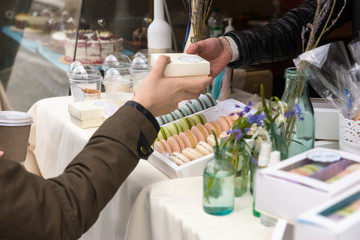 Woman purchasing a French macaron