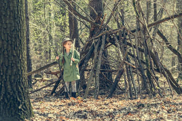 little girl in the wood near  hut