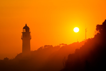 潮岬の潮岬灯台と夕日
