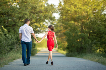 Young couple walks in park