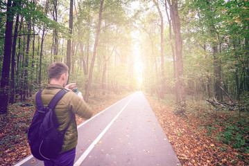 Fototapeta premium Man taking photos in forest