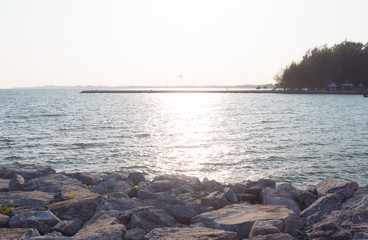 rough rocks and wave surface with sunset