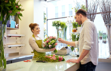 smiling florist woman and man at flower shop