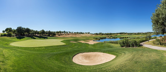 Panorama of a golf course sand trap and collar.