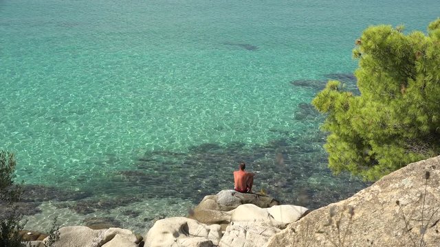 Fisherman on the shore. Filmed in Greece, Santorini Island