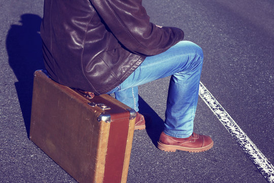 Emigration,resettlement,refugee,migration.The man in jeans with a suitcase.