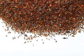 Dry rooibos tea leaves as texture for background. Toned
