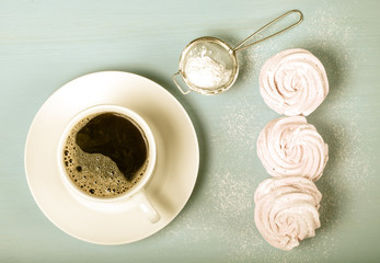 Fresh pink homemade zephyr - marshmallow and white cup of tea on
