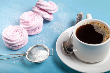 Fresh pink homemade zephyr - marshmallow and white cup of tea on