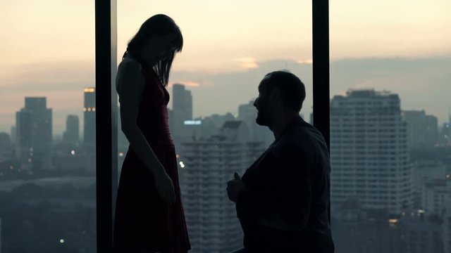 Couple at home, man surprises his girlfriend with marriage proposal 
