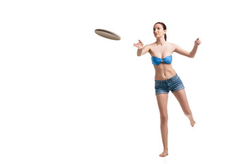 young happy woman playing frisbee over white