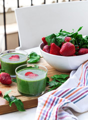 Green spinach smoothie with strawberry