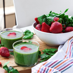 Green spinach smoothie with strawberry