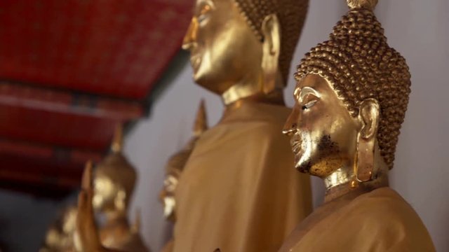 Statues of golden Buddha in temple in Bangkok, Thailand
