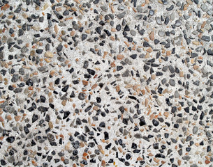colorful gravel stone set in white concrete texture, abstract background