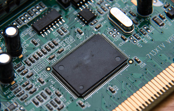 computer circuit Board close up isolated on wooden table