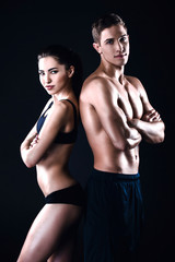 Fototapeta na wymiar Fitness man and woman on black background