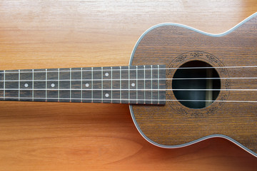 Obraz premium Close up of wooden ukulele on wooden background