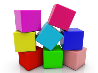Toy cubes in heap in different colors on white