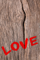 Word "Love" painted on old wooden wall background