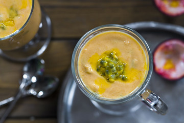 Yogurt dessert with mango and passion fruit - top view