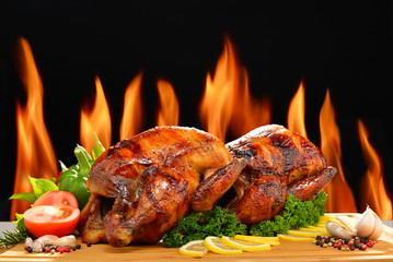 Roast chicken and various vegetables on a chopping wood - obrazy, fototapety, plakaty