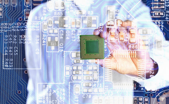 Man holding microchip and electronic circuit board, close up