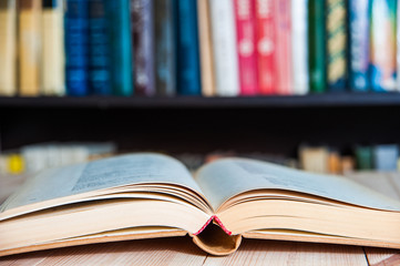 Open book, hardback books on  wooden table. Back to school. 