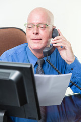 Executive comparing computer and written notes