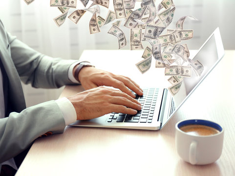Financial concept. Make money on the Internet. Man working with laptop in office