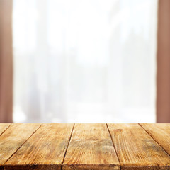 Fototapeta na wymiar Empty wooden table and blurred window background