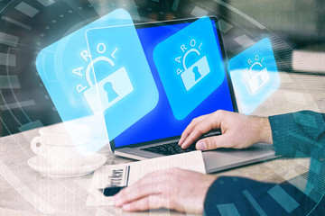Man working on laptop with icons security on virtual display. Technology, internet and networking concept.