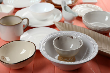 Different tableware on wooden table close up