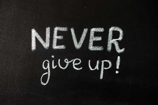 Never give up, business or school motivational words, blackboard, chalkboard, color chalks