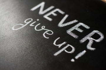 Never give up, business or school motivational words, blackboard, chalkboard, color chalks
