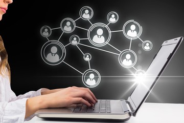 Composite image of woman typing on her laptop